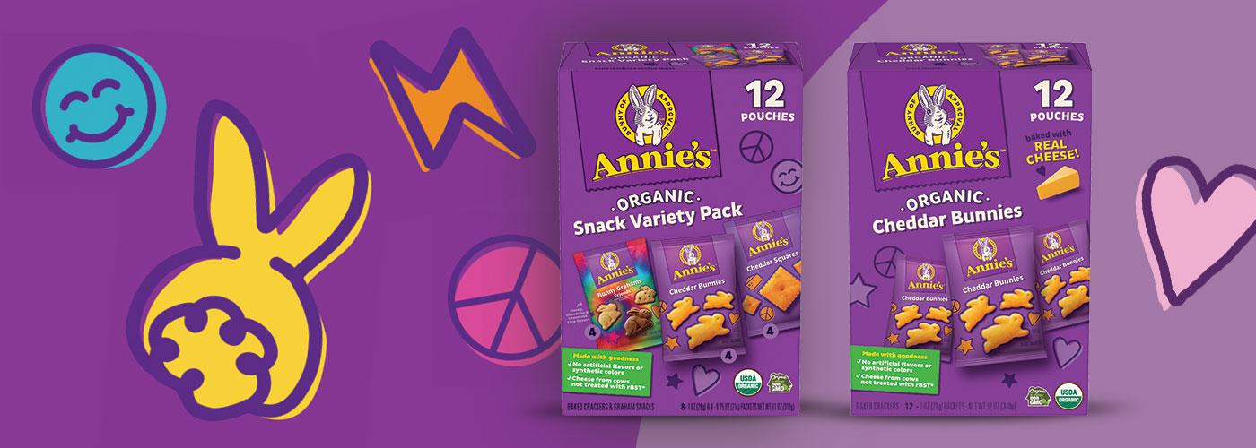 Single boxes of Annie's Organic Snack Variety Pack and Annie's Organic Cheddar Bunnies on a purple background.
