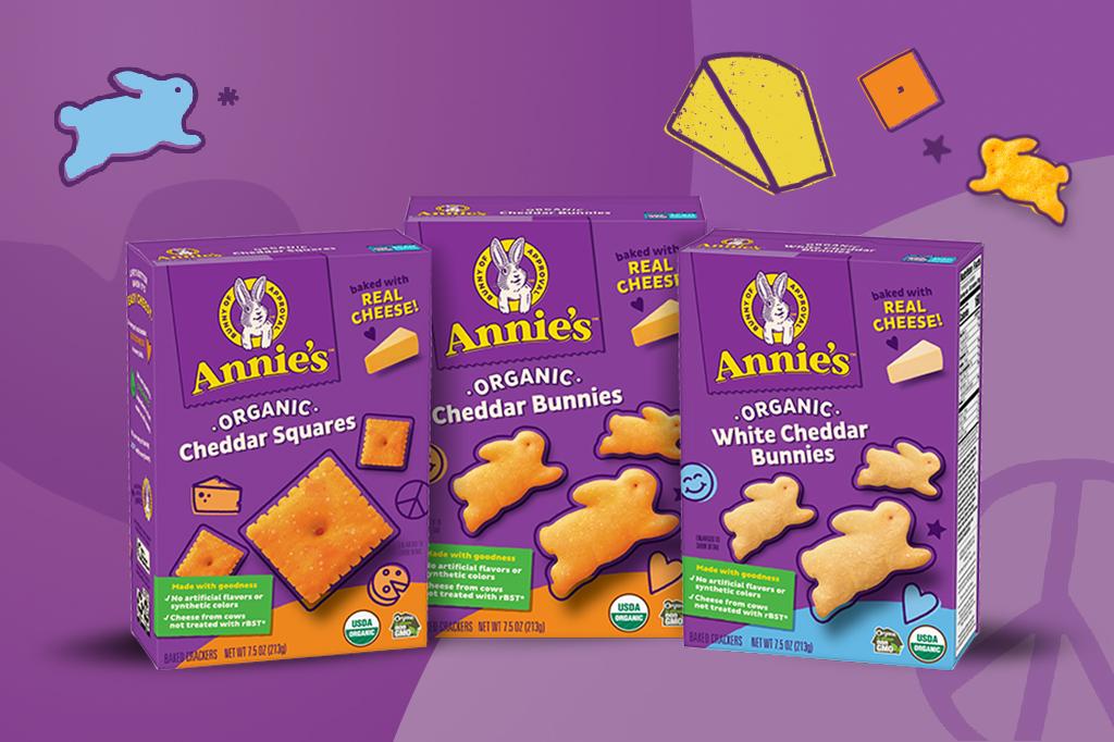 Single boxes of Annie's Organic Cheddar Squares, Annie's Organic Cheddar Bunnies and Annie's Organic White Cheddar Bunnies with a purple background.