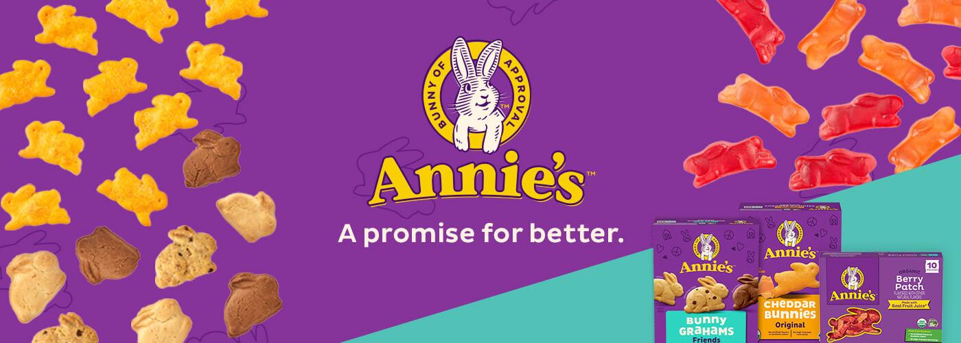 Three front facing pack shots of Bunny Grahams, Cheddar Bunnies and Fruit Snacks Berry Patch in the bottom right corner on a purple & turquoise background with a bunny logo & text saying, "A promise for better". Small Cheddar Bunnies, Bunny Grahams and Fruit Snacks are floating around.