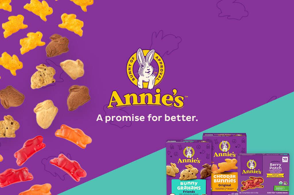Three front facing pack shots of Bunny Grahams, Cheddar Bunnies and Fruit Snacks Berry Patch in the bottom right corner on a purple & turquoise background with a bunny logo & text saying, "A promise for better". Small Cheddar Bunnies, Bunny Grahams and Fruit Snacks are floating on the left side.