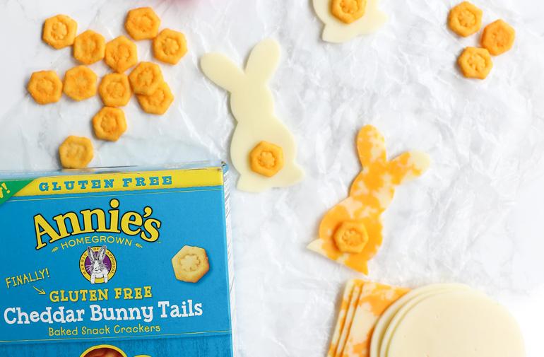 Overhead view of Cheesy Gluten Free Bunnies as they rest on a white cloth surrounded by cheese.