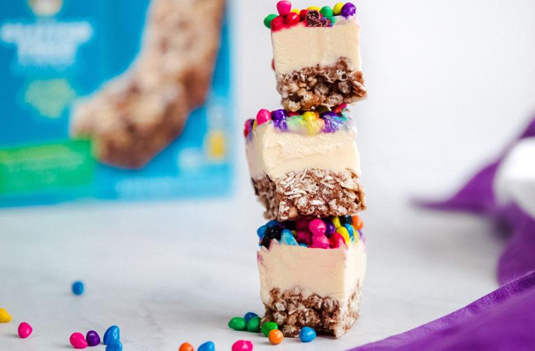 A stack of granola bites with a box of Annie's granola bars in the background