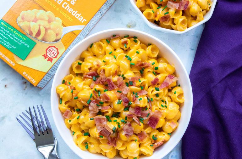 A bowl of cheesy pasta with an Annie's box next to it