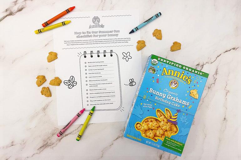 "Annies Hop to it's our summer fun checklist for your bunny" activity sheet with a box of Birthday Cake bunny grahams and crayons.